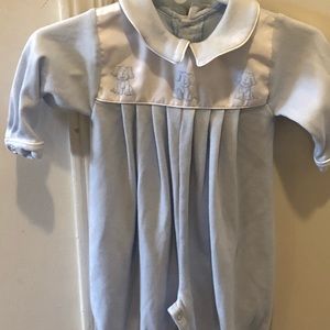 Blue knit romper with embroidered blue puppies.